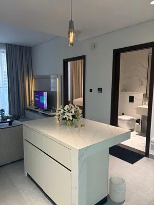 a living room with a white counter with flowers on it at Modern Downtown 1BR Apartment in jumeirah Garden in Dubai