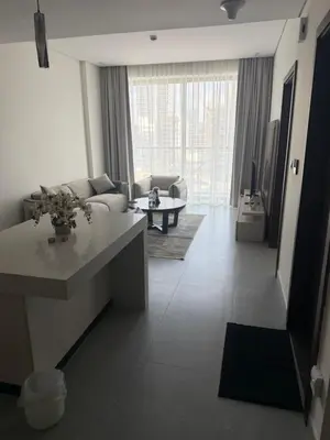 a living room with a couch and a table at Modern Downtown 1BR Apartment in jumeirah Garden in Dubai