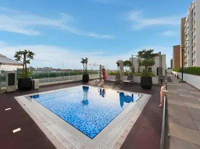 a swimming pool on the roof of a building at Chic Studio in Azizi Riviera Minutes to Downtown in Dubai