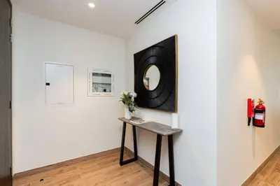 a room with a table and a mirror on the wall at CitiHome Elegant 1BR Jumeirah Living Dubai Marina in Dubai