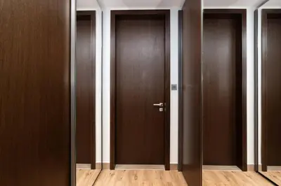 a row of brown doors in a hallway at CitiHome Elegant 1BR Jumeirah Living Dubai Marina in Dubai