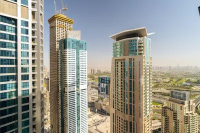 a view of two tall buildings in a city at CitiHome Elegant 1BR Jumeirah Living Dubai Marina in Dubai