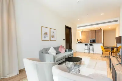 a living room with a couch and a table at CitiHome Refined 1BR Jumeirah Living Marina Gate in Dubai