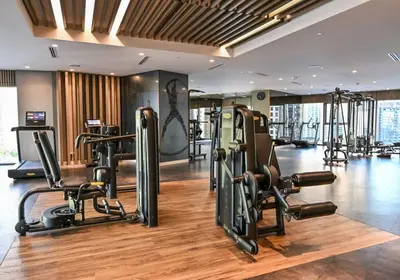 a gym with several treadmills and exercise equipment at Top Amenities, Luxury 2BR, 5 min. to Burj Khalifa in Dubai