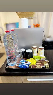 a tray with bottles of water and snacks on a counter at Ruby home in Dubai