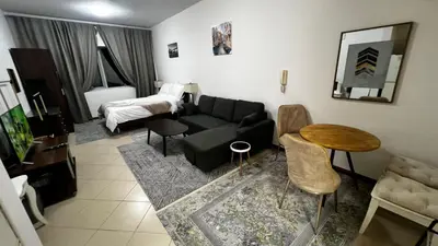 a living room with a couch and a bed at Dream home in Dubai