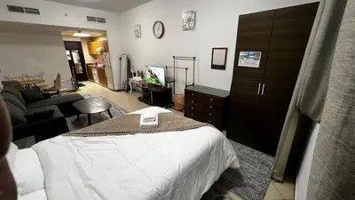 a bedroom with a bed and a living room at Dream home in Dubai