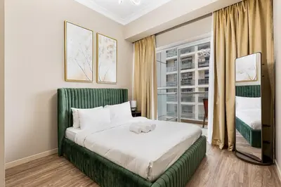 a bedroom with a large bed and a window at Modern 1BR Unit Close to Canal Walk & Burj Khalifa in Dubai
