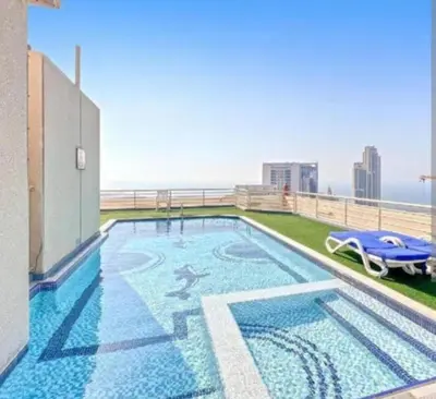 a swimming pool on the roof of a building at Upgraded Sea View 1BR Dubai Marina, Walk Metro & JBR in Dubai