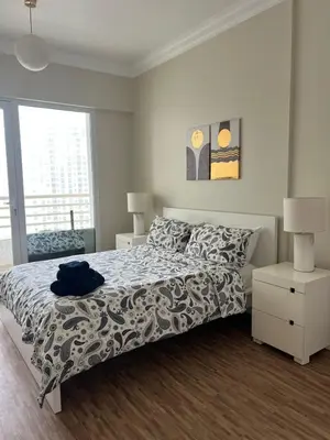 a bedroom with a bed with a blue shirt on it at Upgraded Sea View 1BR Dubai Marina, Walk Metro & JBR in Dubai
