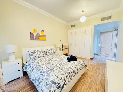 a bedroom with a bed with a cat sitting on it at Upgraded Sea View 1BR Dubai Marina, Walk Metro & JBR in Dubai