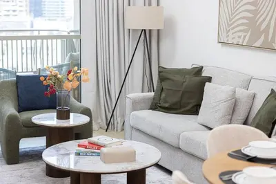 a living room with a couch and a table at Boulevard Chic Modern 2BR with Iconic Street Views in Dubai