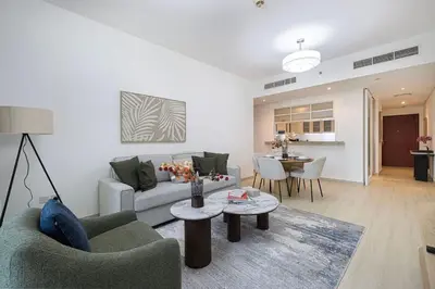 a living room with a couch and a table at Boulevard Chic Modern 2BR with Iconic Street Views in Dubai