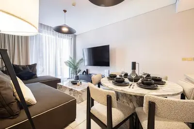a living room with a table and a couch at Iconic Living Contemporary 2BR at Vida Dubai Mall in Dubai