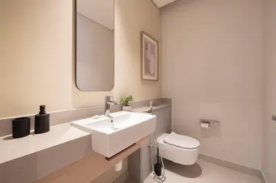 a bathroom with a white sink and a toilet at Iconic Living Contemporary 2BR at Vida Dubai Mall in Dubai