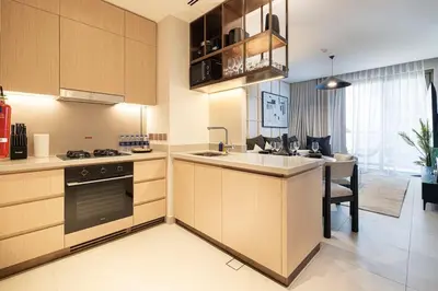 a kitchen with wooden cabinets and a sink and a stove at Iconic Living Contemporary 2BR at Vida Dubai Mall in Dubai