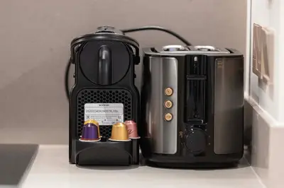 a coffee maker and a toaster sitting on a counter at Heart of Downtown Stylish 2BR at Vida Dubai Mall in Dubai