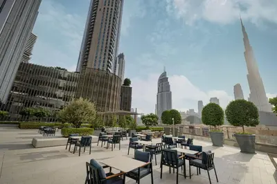 a patio with tables and chairs in a city at Heart of Downtown Stylish 2BR at Vida Dubai Mall in Dubai