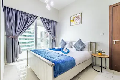 a bedroom with a bed and a large window at Elegant 2BR Business Bay Canal View Gym & Pool in Dubai