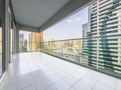 a balcony with a view of a city at Elegant 2BR Business Bay Canal View Gym & Pool in Dubai