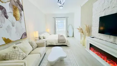 a living room with a couch and a fireplace at Stylish Furnsihed Apartments Opposite Five Hotel In JVC in Dubai