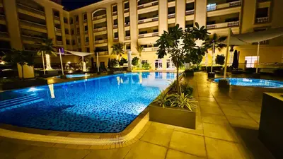 a large swimming pool in the middle of a building at Stylish Furnsihed Apartments Opposite Five Hotel In JVC in Dubai