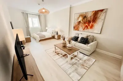 a living room with a couch and a table at Stylish Furnsihed Apartments Opposite Five Hotel In JVC in Dubai