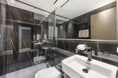 a bathroom with a sink and a mirror at Daniels Chic 1BR with City Skyline Views at JVC in Dubai
