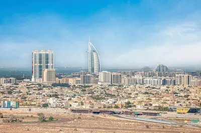 a view of a city with a tall skyscraper at Daniels Chic 1BR with City Skyline Views at JVC in Dubai
