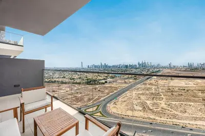 a room with a balcony with a view of a city at Daniels Chic 1BR with City Skyline Views at JVC in Dubai