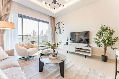 a living room with a couch and a table at Just Moments from Coca-Cola Arena and Metro 1BR, Surrounded by a Vibrant Array of Retail and Dining Outlets, Viridian, Al Wasl by Deluxe Holiday Homes in Dubai