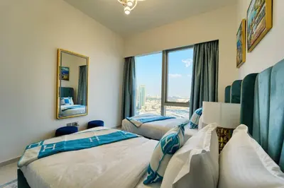 two beds in a room with a large window at ROME x DXB with Full Burj and Fountain View in Downtown Dubai in Dubai