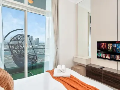 a bedroom with a bed and a large window at Ultra Stylish Luxury Flat w Harbour View in Dubai Marina, Sleeps 10 pax in Dubai