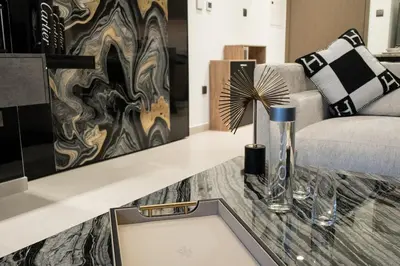 a living room with a table and a couch at Noir x DXB a High Floor 1BDR in Downtown Dubai in Dubai