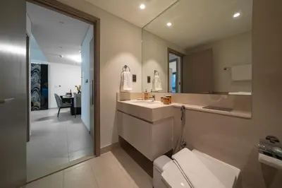 a bathroom with a sink and a toilet and a mirror at Noir x DXB a High Floor 1BDR in Downtown Dubai in Dubai