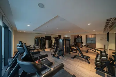 a gym with treadmills and ellipticals in a room at Noir x DXB a High Floor 1BDR in Downtown Dubai in Dubai