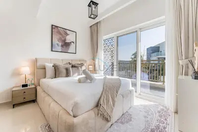 a bedroom with a large bed and a large window at Well-Connected, Family-Friendly Community with Resort-Style Amenities, Minutes from Major Malls and Al Maktoum International Airport - Damac Hills 2 Amargo, Damac Hills 2 by Deluxe Holiday Homes in Dubai
