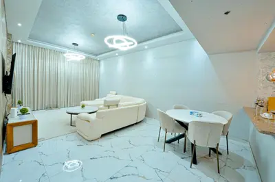 a living room with a couch and a table at Luxestay Holiday Homes in Dubai