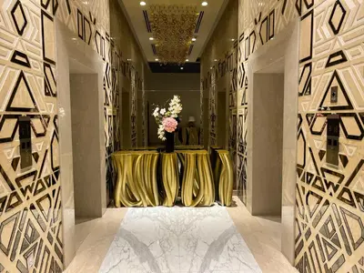 a hallway with a table with a vase of flowers at Luxury Waterfront Studio - Stunning Canal Views in Damac Maison Prive in Dubai