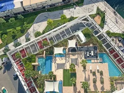 an overhead view of a pool with a roller coaster at Luxury Waterfront Studio - Stunning Canal Views in Damac Maison Prive in Dubai