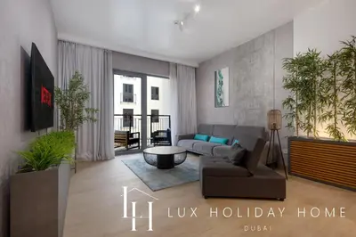a living room with a couch and a table at LUX The La Mer Beach Suite 5 in Dubai