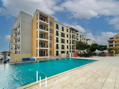 a swimming pool in front of a building at LUX The La Mer Beach Suite 5 in Dubai