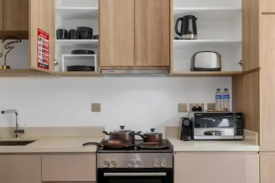 a kitchen with a stove and a microwave at Stylish Missoni Studio with Direct Pool Access in Dubai