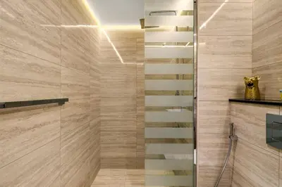 a bathroom with a shower with a glass door at Stylish Missoni Studio with Direct Pool Access in Dubai