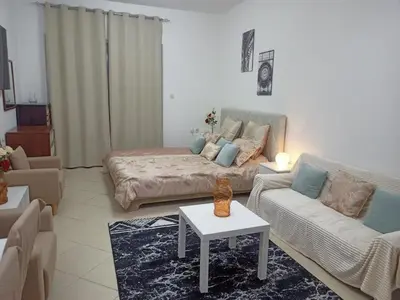 a living room with a couch and a coffee table at Dubai Marina Studio in Dubai
