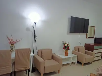 a living room with chairs and a table and a tv at Dubai Marina Studio in Dubai