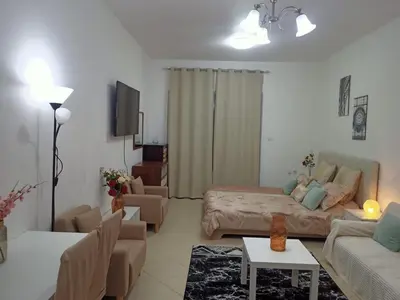 a living room with a couch and a bed in it at Dubai Marina Studio in Dubai
