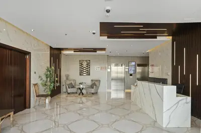 a lobby of a hotel with a table and chairs at Apartment-Private Bathroom in Dubai