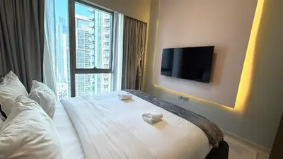 a hotel room with a bed and a large window at Boulevard Sea View Luxury 1 BR Next Dubai Mall in Dubai