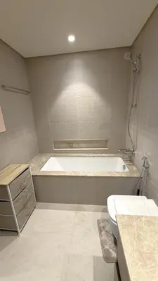 a bathroom with a tub and a toilet and a sink at Boulevard Sea View Luxury 1 BR Next Dubai Mall in Dubai